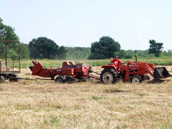 Tractor pulling baler